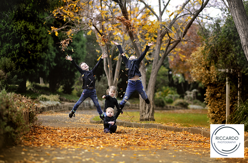 Portraits of children throwing Autumn leaves in the air. Photo by Geelong Photographer Riccardo