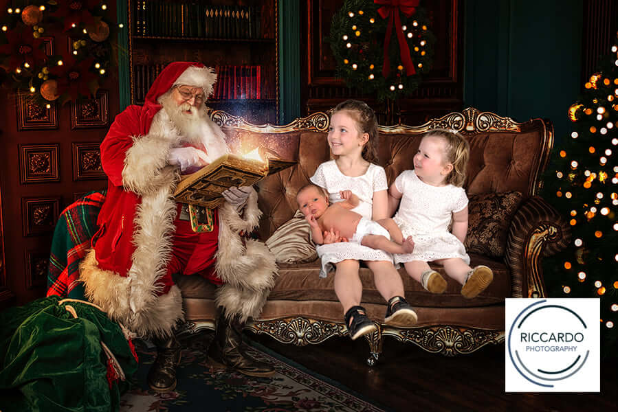 Photo of children having a photo taken with Santa in his workshop in Geelong. 